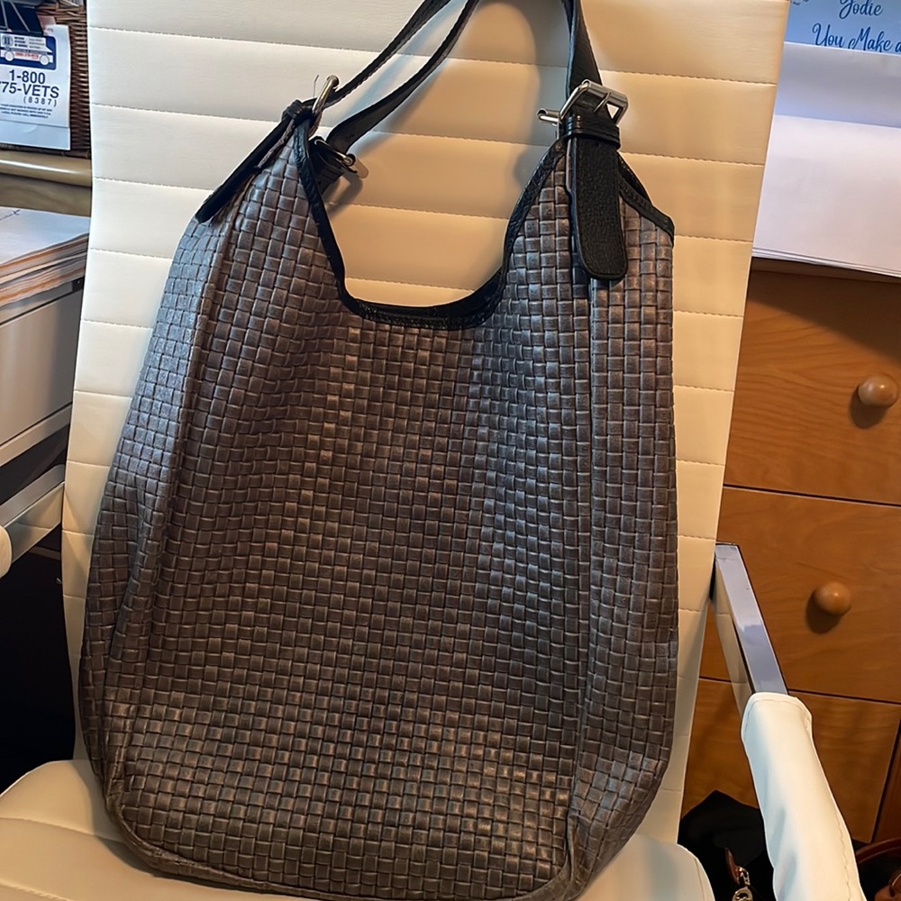 Grey woven bucket bag.